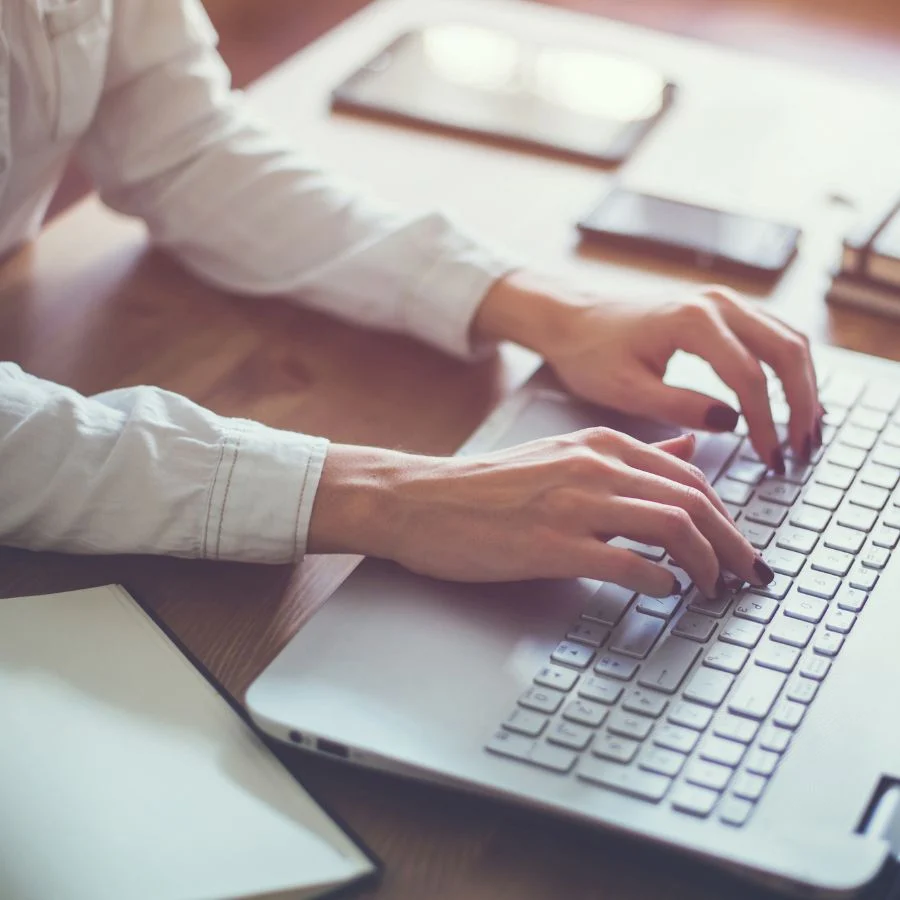 Woman typing on a laptop computer
