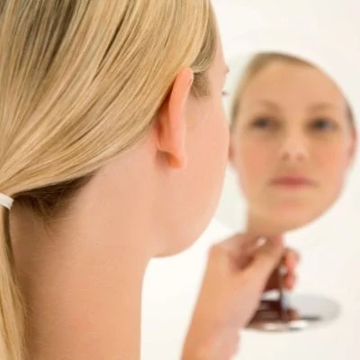 woman looking in mirror