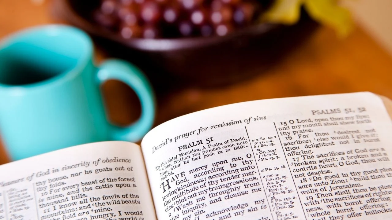 Open Bible with a cup of coffee in the background