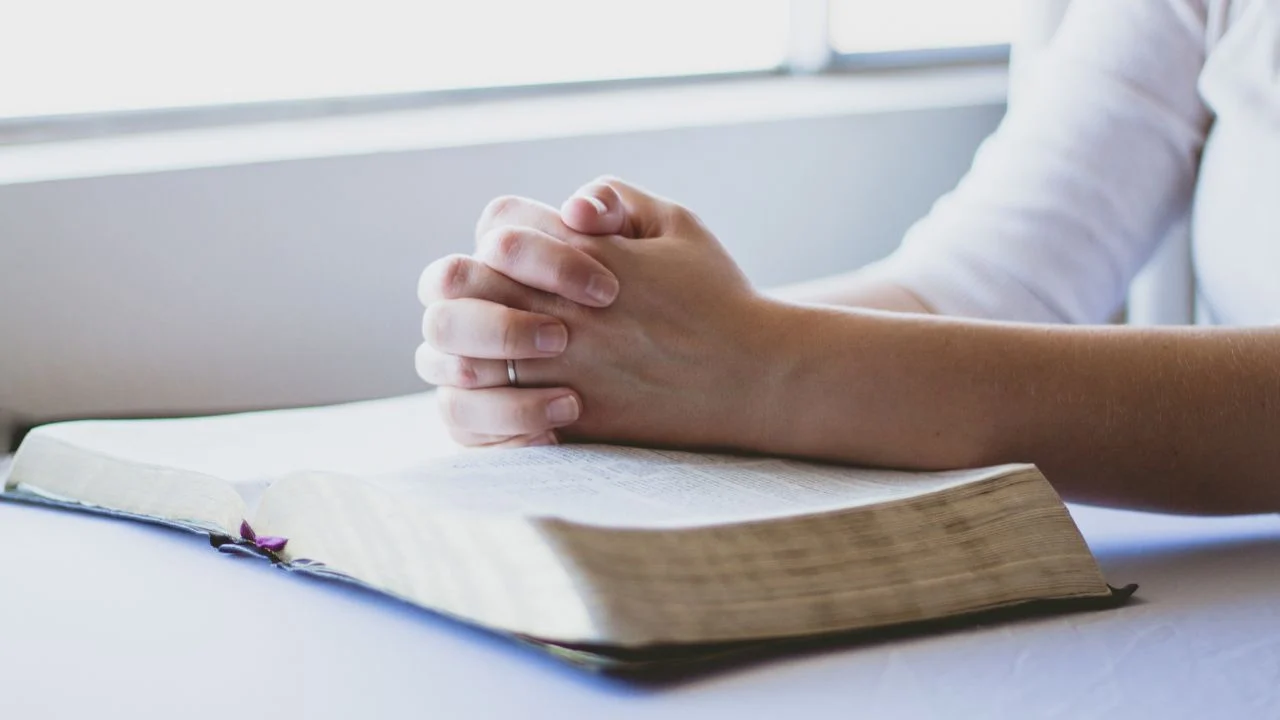 Woman praying with a Bible